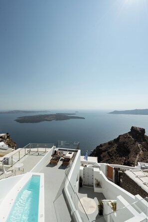 A rooftop pool with a view of the sea and islands.