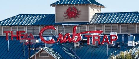 A building with a sign that reads "THE Crab Trap".