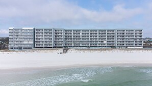 A multi-story hotel with balconies, located adjacent to a sandy beach. - Islander 5006 - Ocean Star (Fort Walton Beach)