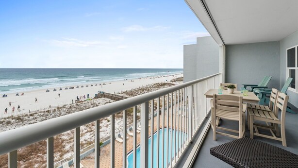 A balcony with a view of the beach, a pool, and outdoor furniture. - Islander 5006 - Ocean Star (Fort Walton Beach)