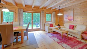 A wooden cabin interior with a dining area, a sofa, and a coffee table. - Feriendorf Wildschonau-near ski Area (Wildschönau)