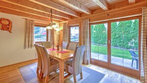 A wooden-paneled dining room with a table, chairs, and curtains. - Feriendorf Wildschonau-near ski Area (Wildschönau)