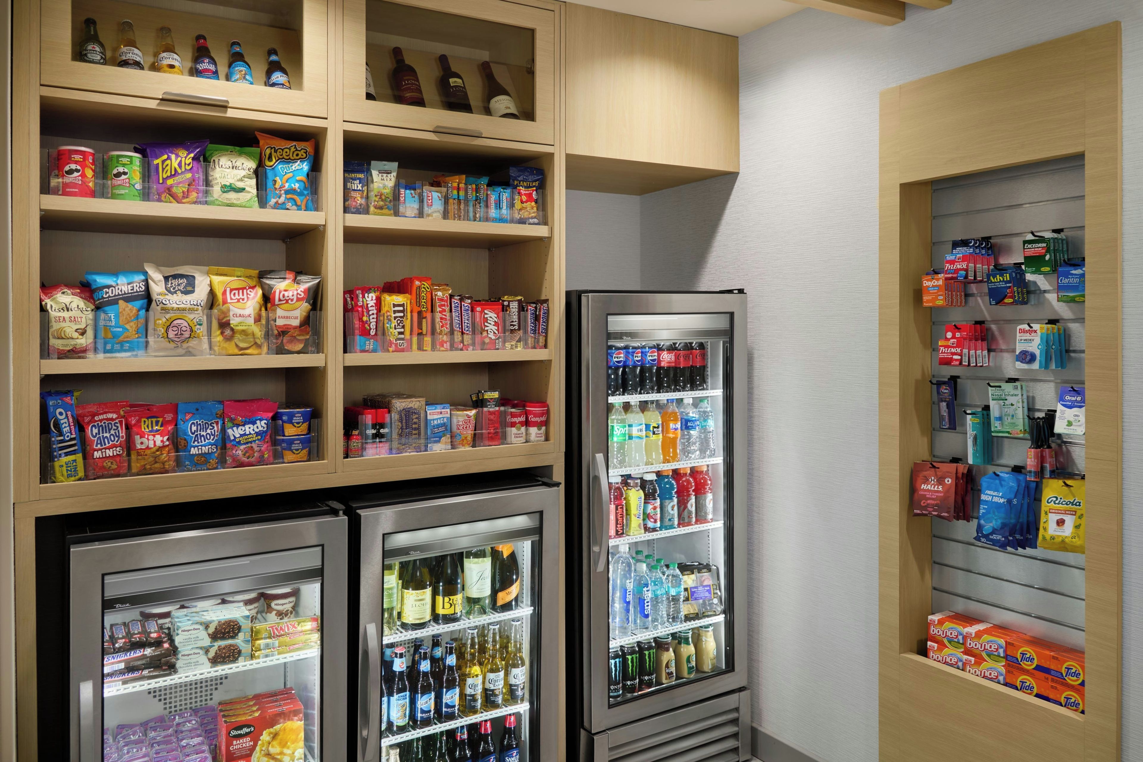 A hotel minibar with snacks, beverages, and toiletries.