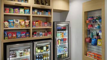 A hotel minibar with snacks, beverages, and toiletries.