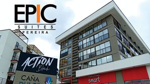 A building with a sign for EPIC Suites and a nearby Action Black store.
