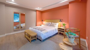 A modern bedroom with a large bed, bedside tables, a desk, and a chair. - Calucé Tesoro by letoH (Medellín)