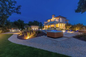 A modern house with a swimming pool, outdoor seating, and a well-lit patio area. - Villa Roko (Malinska-Dubasnica)