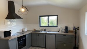 A modern kitchen with a microwave, toaster, sink, and coffee maker.