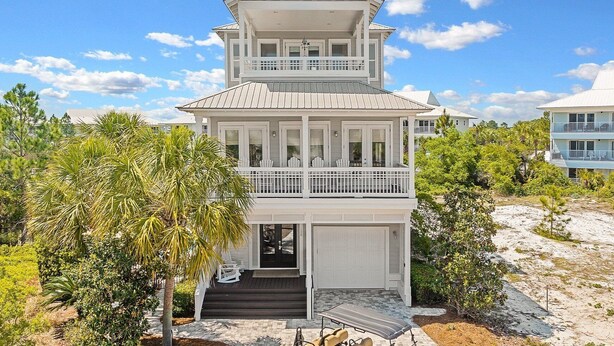 A two-story beachfront house with a balcony, a garage, and a covered porch. - EZ Walk 2 Beach! Private Pool, LSV, FirePit, & Bikes! Pet Friendly! (Santa Rosa Beach)