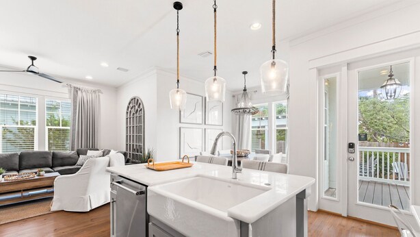 A modern kitchen with a large island, pendant lights, and a view to the outside. - Outdoor Oasis! Walk 2 Shops & Eat! LSV/Golf Cart, 3 Kings & Bikes! (Santa Rosa Beach)