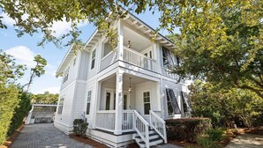 A two-story white house with a porch, a staircase, and a driveway. - Outdoor Oasis! Walk 2 Shops & Eat! LSV/Golf Cart, 3 Kings & Bikes! (Santa Rosa Beach)