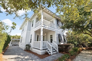 A two-story white house with a porch, a staircase, and a driveway. - Outdoor Oasis! Walk 2 Shops & Eat! LSV/Golf Cart, 3 Kings & Bikes! (Santa Rosa Beach)