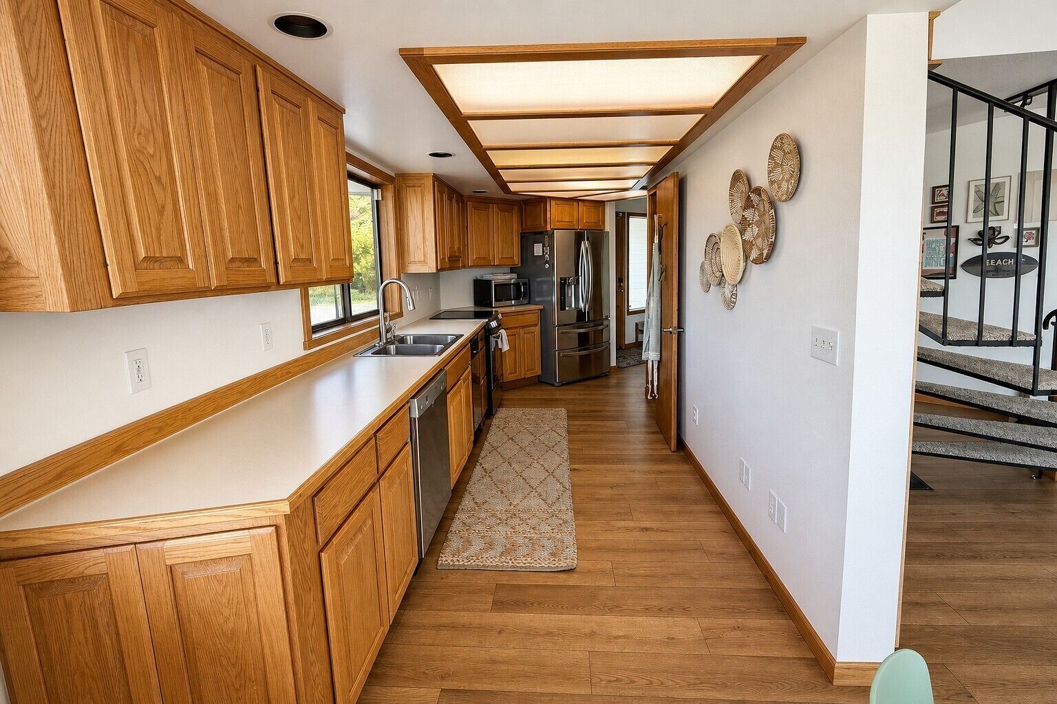 A modern kitchen with wooden cabinets, stainless steel appliances, and a central island.