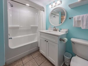 A bathroom with a bathtub, sink, mirror, and toilet. - Roxanne Towers 303 (Myrtle Beach)