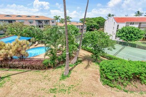 A resort with a swimming pool, tennis court, and lush greenery. - Maui Vista 2310 - Fully Remodeled 1 BR/1 BA Close to Beach (Kihei)