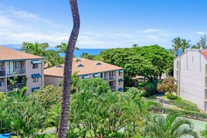 A resort with multiple-story buildings, a tennis court, and lush greenery. - Maui Vista 2408 - Deluxe 2 Bedroom with Ocean View (Kihei)