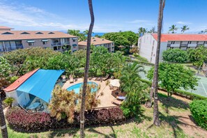 A resort with a swimming pool, palm trees, and a tennis court. - Maui Vista 2408 - Deluxe 2 Bedroom with Ocean View (Kihei)