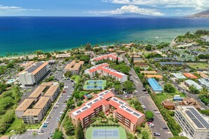 An aerial view of a coastal residential area with buildings, roads, and a beach. - Maui Vista 2408 - Deluxe 2 Bedroom with Ocean View (Kihei)