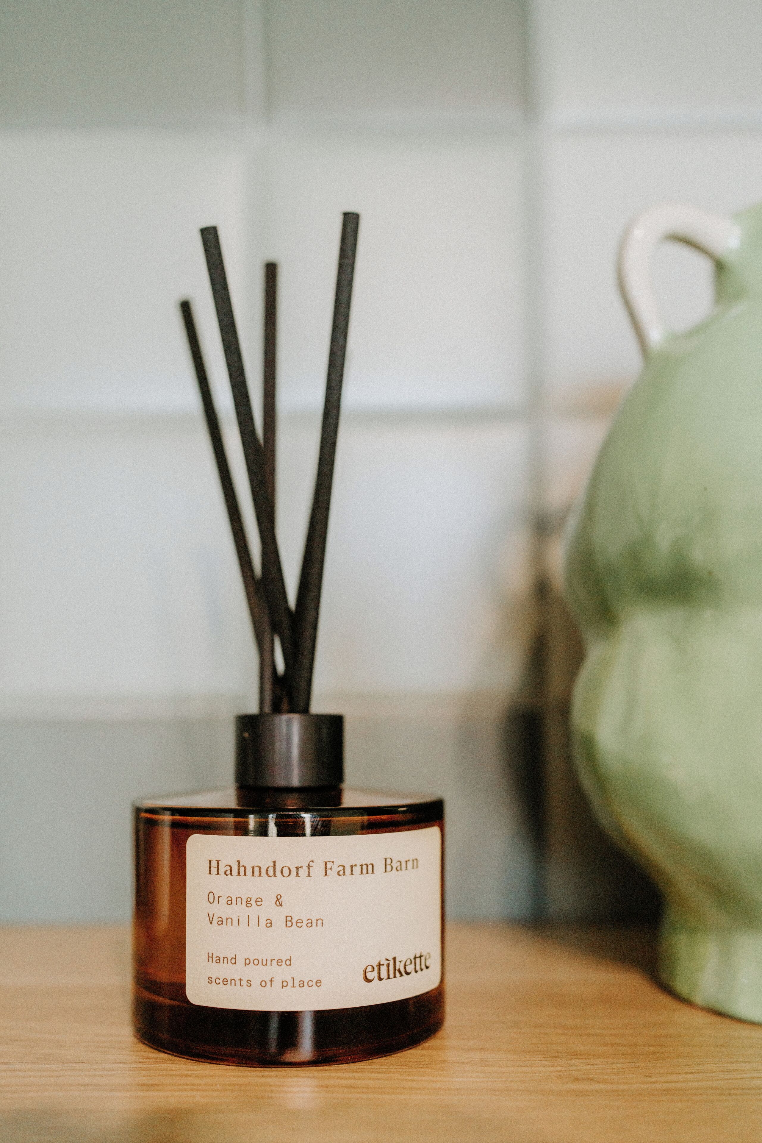 A bottle of Hahndorf Farm Barn Orange & Vanilla Bean hand poured scents of place.