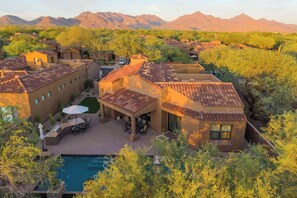 A residential area with multiple houses, a swimming pool, and a mountainous backdrop. - 4BR The Talon Trail Home: Pool, Spa,  Golf Access (Scottsdale)