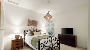 A bedroom with a bed, bedside lamps, a television, a dresser, and a hanging light fixture. - 4BR The Talon Trail Home: Pool, Spa,  Golf Access (Scottsdale)