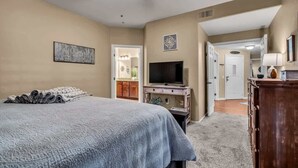 A bedroom with a bed, a TV, and a desk. - Beautiful pool oasis near TPC Scottsdale (Scottsdale)