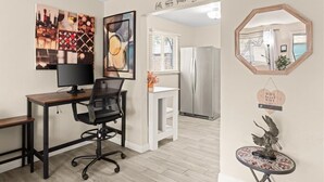 A modern kitchen with a wooden dining table, a black office chair, and a refrigerator. - Exclusive BBQ oasis, mins to Papago Park (Phoenix)
