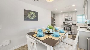 A modern kitchen with white cabinets, a microwave, and a stove. - Historic Coronado retreat with outdoor fire pit (Phoenix)