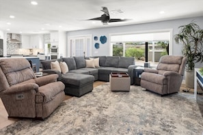 A modern living room with a sectional sofa, two recliners, and a coffee table. - 3BR desert retreat with mountain views (Queen Valley)