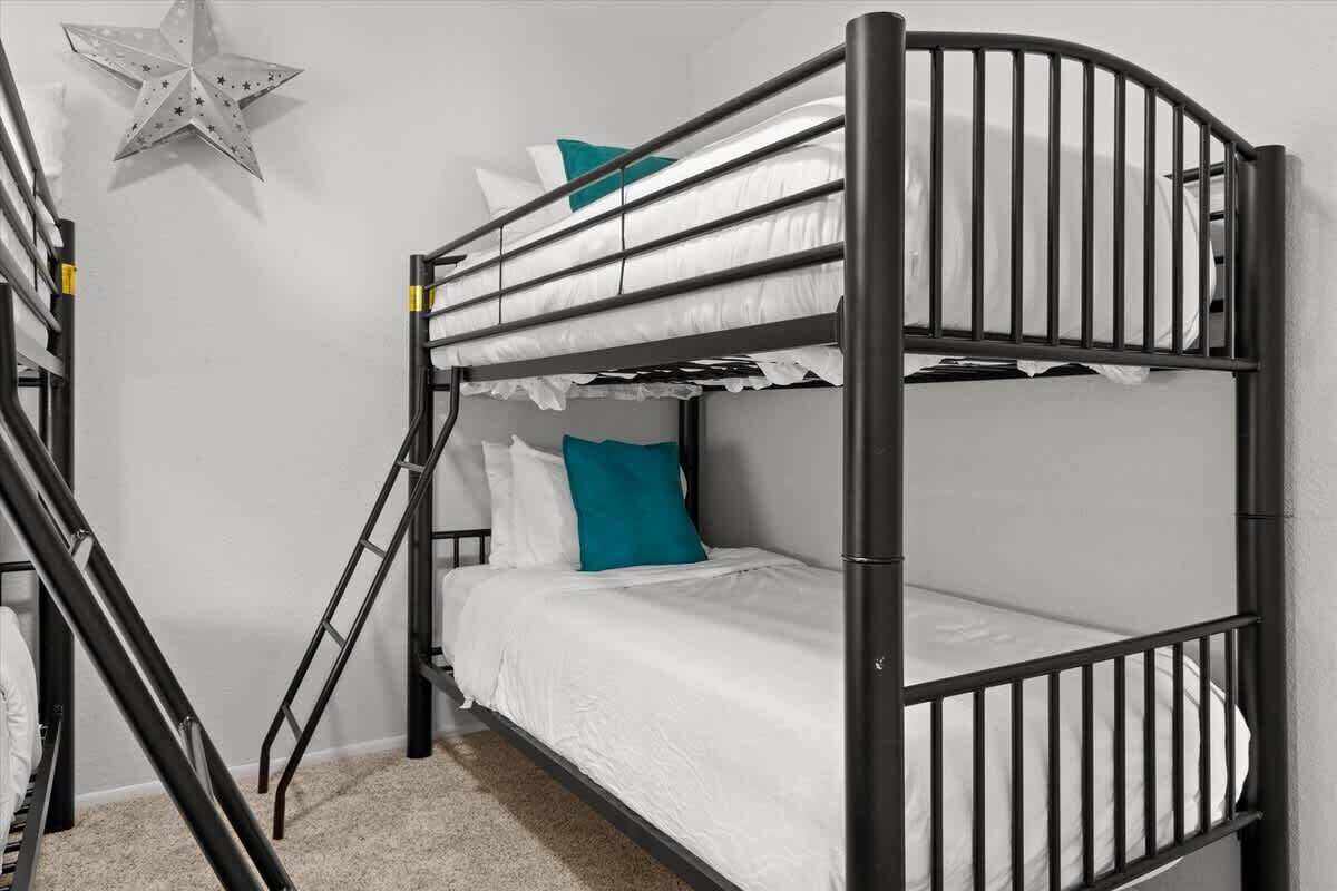 A bunk bed with a star decoration on the wall.