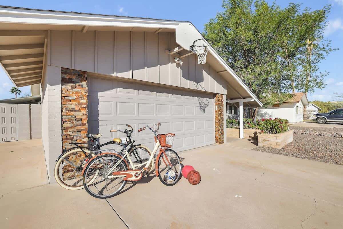 A garage with two bicycles and a basketball.
