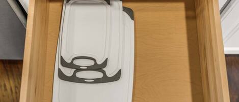 A drawer with a white and black object inside.