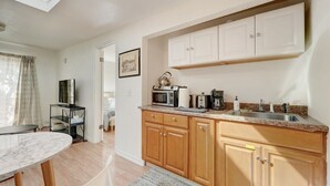 A compact kitchen with wooden cabinets, a microwave, a coffee maker, and a sink. - Marbella Lane - Cozy 1BR in Palo Alto DWNTN Hub (Palo Alto)