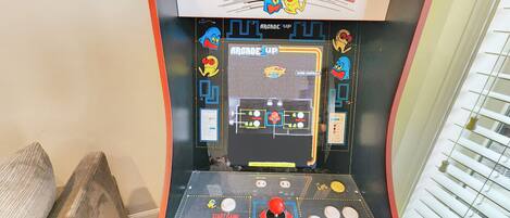 A Pac-Man arcade game with a control panel, game screen, and score display.