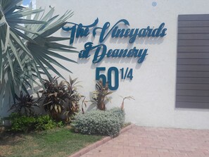 A sign for 'The Vineyards at DeAnery' with a partial address '50 1/4'. - Charming 1 Bedroom Apartment Unit in the Heart of The City. (Kingston)
