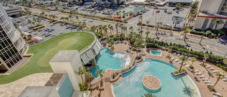 A resort with multiple swimming pools, a golf course, and beachfront views.