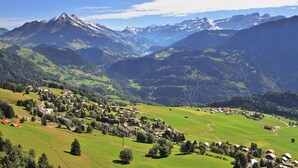 A mountainous landscape with a village nestled in the valley.