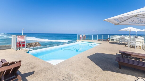 A pool area with a lifebuoy, a sign indicating no climbing or sitting on the pool ledge, and a pool depth of 1.6 meters. - Coastal Retreat | Terrace | Pool | Sea Views (Margate)