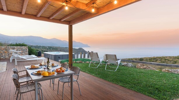 A wooden deck with a table set for a meal, overlooking a scenic view of the sea and mountains. - Villa Scogliera with sea view and pool (Castellammare del Golfo)