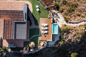 An aerial view of a property with a swimming pool, outdoor seating area, and a patio. - Villa Scopello with sea view and pool (Castellammare del Golfo)