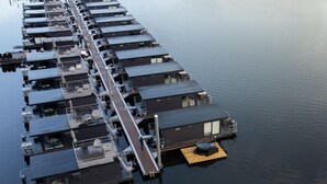 A floating hotel with multiple levels, each featuring balconies and outdoor seating areas.