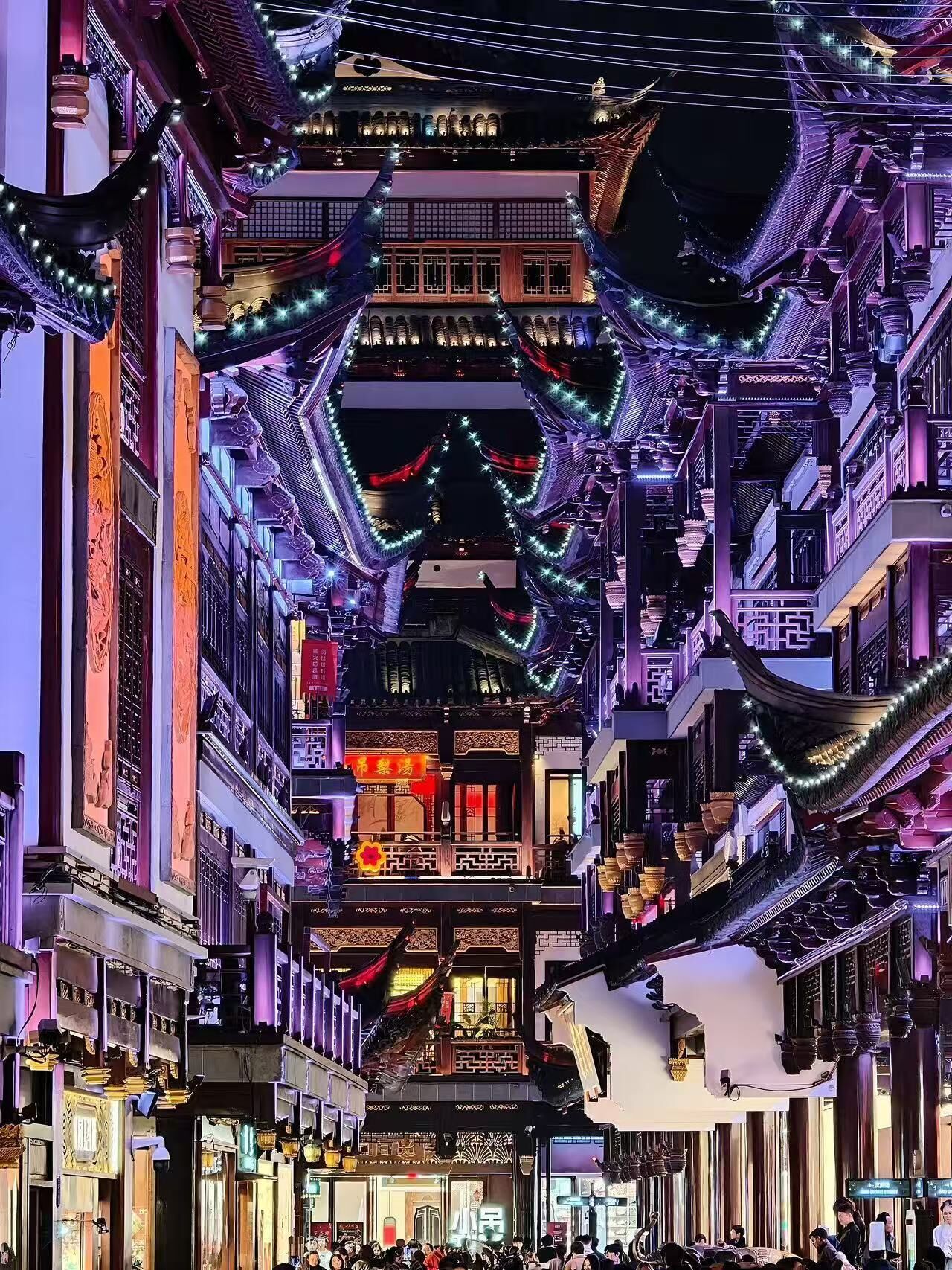 A traditional Chinese street at night with illuminated buildings and decorations.
