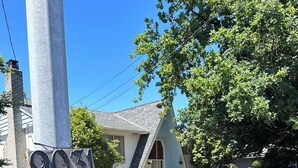 A house with the number 9031 on a pole, a driveway, and several trash bins. - Spacious 8-bedroom house in gorgeous Richmond with AC (Richmond)