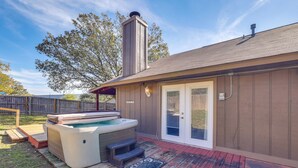A hot tub with steps and a wooden deck, a covered patio, and a chimney. - Private Pool & Hot Tub: Dog-Friendly Live Oak Home (Live Oak)