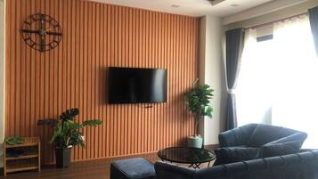 Business Studio, Balcony, Beach View | Living area | 45-inch flat-screen TV with cable channels