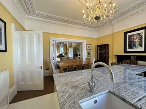 A well-lit kitchen with a granite countertop, a modern faucet, and a chandelier. - Stunning exclusive apartment in Clifton, Bristol, UK 2 bedrooms 6 beds 2 baths (Bristol)