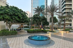 Outdoor spa tub - Stylish 1BR Retreat with Pool & Stunning City View (Dubai)