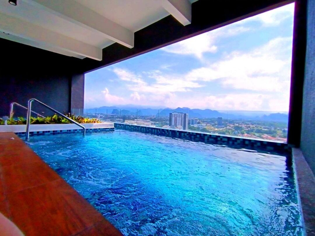 A swimming pool with a view of a cityscape and mountains.