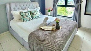 A modern bedroom with a bed, a ceiling fan, a window with curtains, and a view of greenery outside. - The Horizon Ipoh Skyline By Grab A Stay (Ipoh)