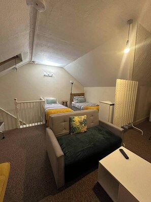 A compact room with a bunk bed, a desk, a chair, and a radiator. - Serene Southampton Apartment With 3 Bedrooms (Southampton)